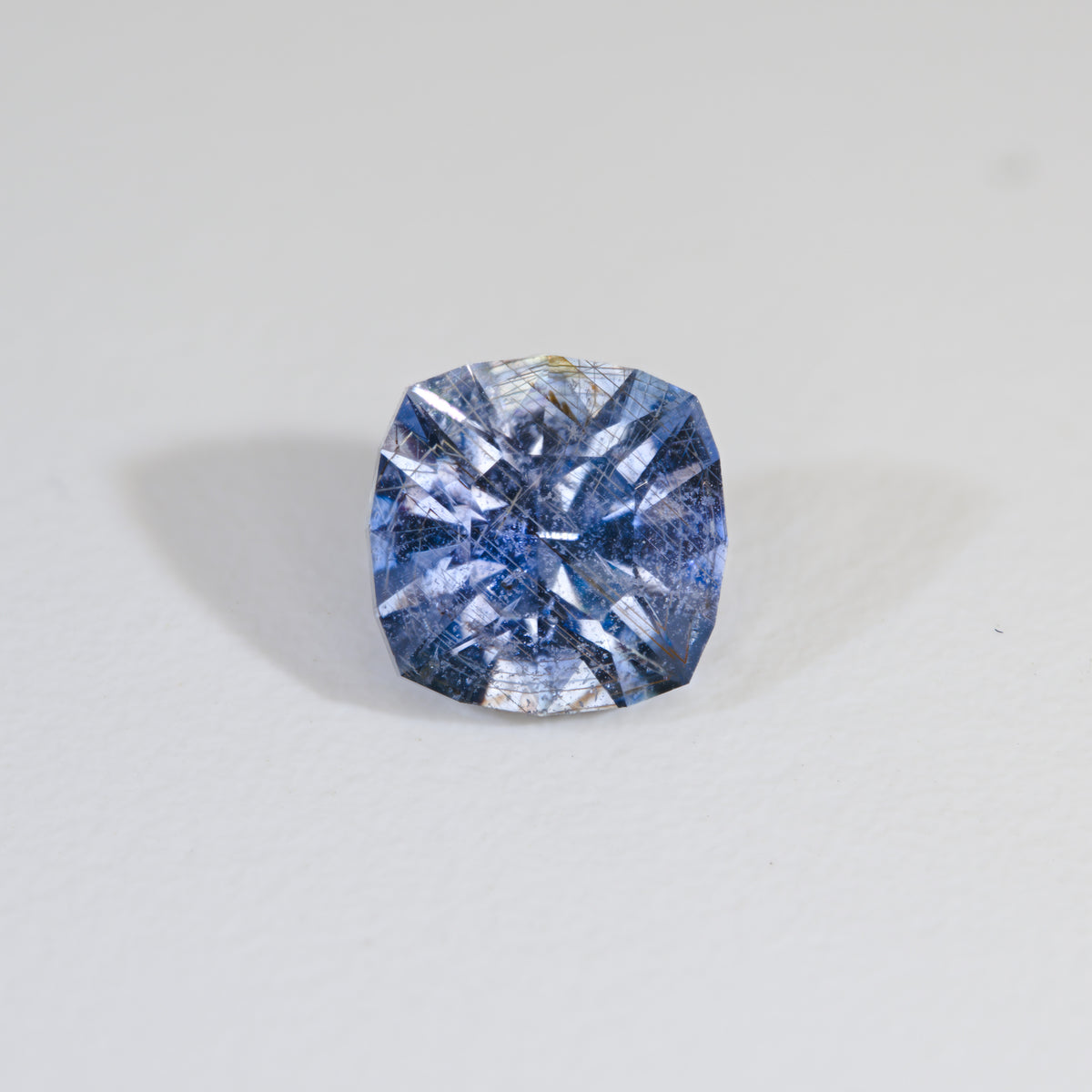 Cushion cut Icy Sky Blue Sapphire with Rose Channels on white background